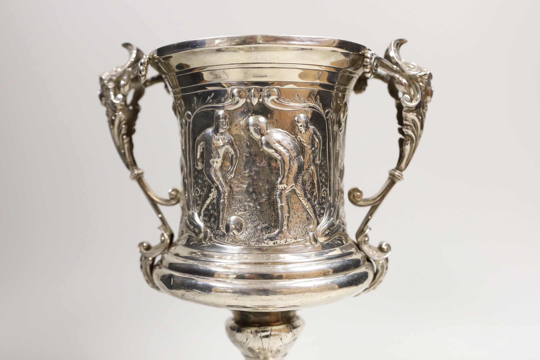 FOOTBALL INTEREST- A late Victorian silver two handled presentation trophy cup, embossed with footballers and inscribed ' Vernon Wentworth Challenge Cup, presented top The Brighton Football Association by Bruce c. Vernon